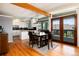 Modern dining room with hardwood floors, stylish lighting, and access to an outdoor deck at 4545 S Lipan Ct, Englewood, CO 80110