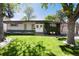 Charming single-story home featuring a large front yard and beautifully landscaped greenery at 4545 S Lipan Ct, Englewood, CO 80110