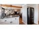 Open kitchen area with a breakfast bar, stainless steel refrigerator, and hardwood floors at 4545 S Lipan Ct, Englewood, CO 80110
