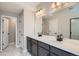 Stylish bathroom with double vanity, ample countertop space, and sleek black fixtures at 8321 Mount Kataka St, Littleton, CO 80125