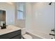 Bathroom with white subway tiles, tub-shower combo, modern fixtures and natural light at 8321 Mount Kataka St, Littleton, CO 80125