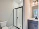 Modern bathroom with white tile shower, glass door, and sleek vanity at 8321 Mount Kataka St, Littleton, CO 80125