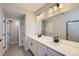 Stylish bathroom boasts double vanity, contemporary lighting, and a sleek design at 8321 Mount Kataka St, Littleton, CO 80125