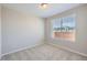 Bright bedroom featuring a large window and plush carpeting, perfect for relaxation at 8321 Mount Kataka St, Littleton, CO 80125