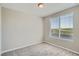 Bedroom with a view from the window, neutral decor, and plush carpeting at 8321 Mount Kataka St, Littleton, CO 80125