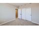 This is a bedroom with carpet, closet, and entry door at 8321 Mount Kataka St, Littleton, CO 80125