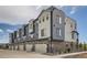 A modern townhome with brick accents and spacious two car garages at 8321 Mount Kataka St, Littleton, CO 80125