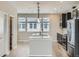 Bright kitchen featuring stainless steel appliances, a spacious island, pantry, and lots of natural light at 8321 Mount Kataka St, Littleton, CO 80125