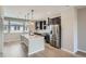 Modern kitchen featuring gray cabinets, stainless steel appliances, a spacious island and pendant lighting at 8321 Mount Kataka St, Littleton, CO 80125