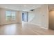 Bright, open living room with luxury vinyl flooring, a sliding glass door, and staircase at 8321 Mount Kataka St, Littleton, CO 80125