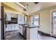 Bright kitchen featuring white cabinets, stainless steel appliances, skylight, and center island at 5738 W Canyon Ave, Littleton, CO 80128