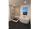 Spa-like bathroom with standalone tub, tiled shower, and large window providing natural light at 5626 W 142Nd Ave, Broomfield, CO 80020