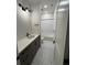 Clean bathroom featuring a vanity with dark cabinets, modern lighting, and a tiled shower/tub combo at 5626 W 142Nd Ave, Broomfield, CO 80020