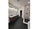 Modern bathroom featuring double vanity, walk-in shower with tile accents and black fixtures at 5626 W 142Nd Ave, Broomfield, CO 80020