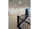 Light-filled bonus room with neutral carpet, recessed lighting, and black metal railing at 5626 W 142Nd Ave, Broomfield, CO 80020