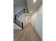 Bright foyer with hardwood floors, staircase with black metal railing, and view to the front door at 5626 W 142Nd Ave, Broomfield, CO 80020