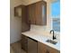 Modern kitchen with stainless steel appliances, white countertops, and dark cabinets at 5626 W 142Nd Ave, Broomfield, CO 80020