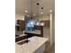 Kitchen featuring quartz countertops, modern pendant lighting, and stainless steel appliances at 5626 W 142Nd Ave, Broomfield, CO 80020