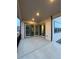 Covered patio with concrete floor and large sliding glass doors leading to the interior at 5626 W 142Nd Ave, Broomfield, CO 80020
