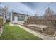 This backyard features an artificial turf lawn, a paver patio, and wood planter boxes at 3956 Kalamath St, Denver, CO 80211