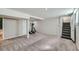 Spacious finished basement with gray carpet and neutral walls leading to stairs and storage at 3956 Kalamath St, Denver, CO 80211