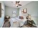 Bedroom featuring a comfortable bed with stylish decor, a ceiling fan, and natural light from the window at 3956 Kalamath St, Denver, CO 80211