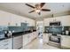 Modern kitchen with white cabinets, stainless steel appliances, and blue backsplash tiles at 3956 Kalamath St, Denver, CO 80211
