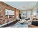 Stylish living room showcasing a decorative brick wall, modern furnishings, and bright natural light at 3956 Kalamath St, Denver, CO 80211