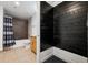 Bathroom featuring a shower/bathtub, wood accent wall with hooks, and a tile floor at 891 14Th St # 2105, Denver, CO 80202