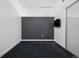 Bedroom with gray accent wall, tv, and a sliding door closet with carpeted floors at 891 14Th St # 2105, Denver, CO 80202