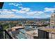 Expansive city view featuring high-rise buildings and the beautiful mountain skyline in the background under a partly cloudy sky at 891 14Th St # 2105, Denver, CO 80202