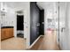 Hallway with hardwood floors, access to the bathroom, and a view to the modern kitchen at 891 14Th St # 2105, Denver, CO 80202