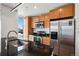 Bright kitchen features stainless steel appliances, granite counters, and stylish cabinets with a window view of the city at 891 14Th St # 2105, Denver, CO 80202