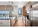 Modern kitchen features stainless steel appliances, granite counters, and a window view of the city skyline at 891 14Th St # 2105, Denver, CO 80202