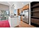 Modern kitchen features stainless steel appliances, wood cabinets, a kitchen island with a sink, and a city view at 891 14Th St # 2105, Denver, CO 80202