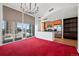 Contemporary open living space features a sleek kitchen, city view, and chic chandelier at 891 14Th St # 2105, Denver, CO 80202
