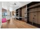 Open living space with wood floors, a built-in workspace, and a kitchen visible in the background at 891 14Th St # 2105, Denver, CO 80202