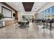 Community lounge area with gourmet kitchen, dining table, bar seating, and floor-to-ceiling windows at 891 14Th St # 2105, Denver, CO 80202