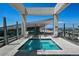 A rooftop pool with lounge chairs is surrounded by a concrete frame and glass windows at 891 14Th St # 2105, Denver, CO 80202