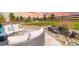 Landscaped backyard area with patio seating area has a rock garden and green grass, perfect for relaxing at 11522 Trona Ct, Parker, CO 80138