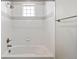 Clean bathroom with white tiled shower and tub combination and a window at 11522 Trona Ct, Parker, CO 80138