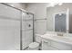 Bright bathroom features a glass shower, toilet, vanity, and sink with tile, modern fixtures and neutral decor at 11522 Trona Ct, Parker, CO 80138