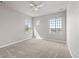 Bright bedroom with ample natural light featuring two large windows and neutral carpeting at 11522 Trona Ct, Parker, CO 80138