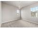 Bedroom features a chandelier, plush carpet, and natural light from large windows at 11522 Trona Ct, Parker, CO 80138