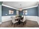 Elegant dining room with wainscoting, stylish lighting, and seating for six at 11522 Trona Ct, Parker, CO 80138