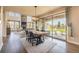 Bright dining room with dark wood floors, modern lighting and view of the outdoor patio and fireplace at 11522 Trona Ct, Parker, CO 80138