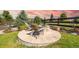 A backyard stone firepit area is shown with wood chairs and grassy perimeter, perfect for outdoor gatherings at 11522 Trona Ct, Parker, CO 80138