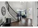 Grand foyer showcasing a curved staircase, hardwood floors, and a view into the living room at 11522 Trona Ct, Parker, CO 80138