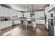 Spacious kitchen with white cabinets, stainless steel appliances, and a center island at 11522 Trona Ct, Parker, CO 80138