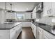 Gourmet kitchen with a large island, stainless steel appliances, and stylish pendant lighting at 11522 Trona Ct, Parker, CO 80138